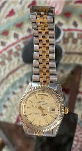 Need info on this watch tried to do research couldn't find a day date with a good face and silver outer links is it real or fake? Someone gave it to my
