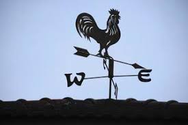 The old wind vane with a rooster symbol icon on the roof, traditional technology equipment for forecast and measuring windy weather in the air, vintage decoration, aiming wind direction instrument. 13453153 Stock