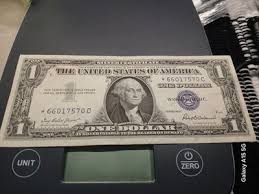 1957 $1 silver certificate star note. (EF) with ink error on ...