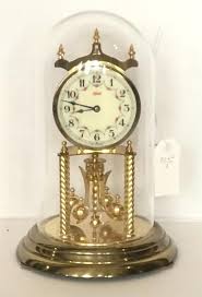 Lot - German anniversary clock under a glass dome, made by ...