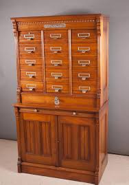 Lot - LATE VICTORIAN WALNUT FILE CABINET IN TWO SECTIONS