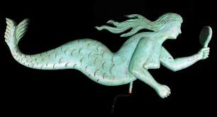 Sold at Auction: Mermaid weathervane, hand carved wooden folk art, depicting a mermaid looking at her reflection in a mirror, painted turquoise, carved on each side, attached copper mount, includes bracket and