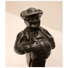 Colonial man cast iron doorstop in black paint on stepped base. For Sale at Ruby Lane
