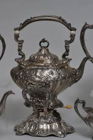 Lot - Gorham Chantilly pattern hand chased Sterling silver five piece tea set. Coffee pot- 10" high. Slight dimples on center cartouche. Teapot- 10" wide. Good condition. Creamer- 3/8" small dent on