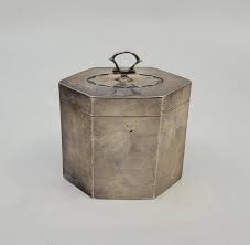 A silver tea caddy, by Brook & Son, Sheffield 1911, of hexagonal form with bat wing