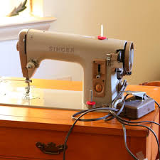 Sold at Auction: Vintage Singer sewing machine in a cabinet