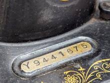 Sold at Auction: An Edwardian Singer Sewing Machine with key.