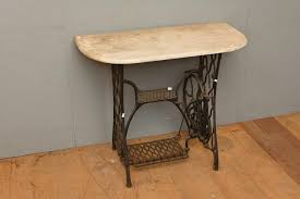 Sold at Auction: A CAST IRON BASED SINGER SEWING MACHINE TABLE BASE WITH SEMI CIRCULAR MARBLE TOP (A/F) (75H X 90W X 43D CM) (PLEASE NOTE THIS HEAVY...