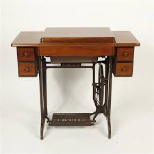 Sold at Auction: Vintage 1950s Singer 15- sewing machine and table with drawers and cast iron treadle base.