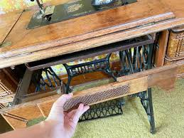 ANTIQUE SINGER SEWING CABINET & SINGER SPHINX SEWING MACHINE | EstateSales.org
