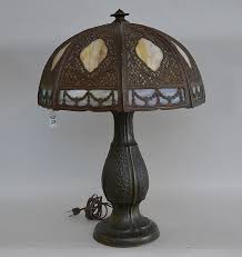Sold at Auction: ANTIQUE SLAG GLASS LAMP on cast patinated metal base. Kylix and art deco patterns throughout shade. Acorn finial. Appears unmarked. MEASUREMENTS: 22 1/2"" tall. x 16" shade diameter. CONDITION:
