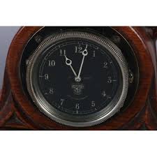 THOMPSON OF KILBURN 'MOUSEMAN', an early oak mantel clock, c.1930s, of arched outline, carved in rel