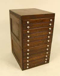 Lot - AN OAK TWELVE DRAWER SPOOL CABINET