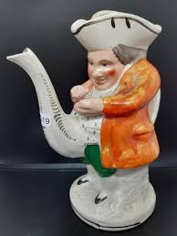 A 19th century Staffordshire toby teapot in the form of a ...