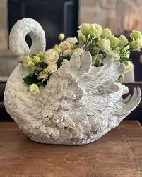 I love using unexpected things for a flower vase. I recently found this swan planter at a junk shop. Just use a plastic container to hold and place your flowers in flower