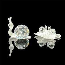 Sold at Auction: 2pc Swarovski Crystal Snail Figurines