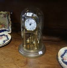 Sold at Auction: Early C20th brass anniversary clock under glass dome