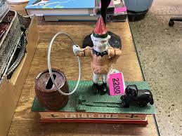 Sold at Auction: Cast Iron Trick Dog Bank