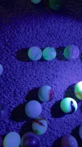 What are these old glass marbles that glow under UV light?