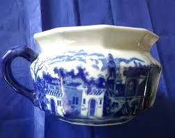 A White Victorian Style Ceramic Chamber Pot That Has a Blue ...