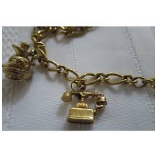 Vintage AVON Gold Plated Charm Bracelet with Owl, Telephone, Cowboy . For Sale at Ruby Lane