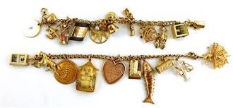 Lot - JEWELRY: Two gold charm bracelets: 14K charm bracelet ...