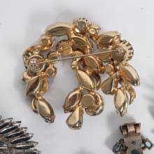 Sold at Auction: Vintage jewelry 5pc. group of Eisenberg emerald rhinestone brooch, sterling silver earrings, vintage fur clip, aurora borealis brooch, and dimensional rhinestone brooch. 2 1/4"H x 1 1/2"W (Eisenberg brooch)