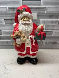 Christmas resin figurine Santa holding gifts in red suit ...