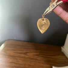 Gold pendant in heart shaped design with white shell opal ...