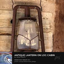 Antique Lantern on Log Cabin Wall Photograph by Linda Phelps - Pixels