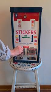 I repurposed an old stamp machine to dispense mini stickers ...
