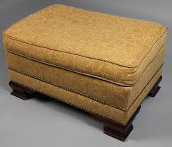 Lot - ROSE TARLOW FABRIC UPHOLSTERED WING CHAIR AND COORDINATING OTTOMAN