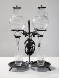 Sold at Auction: Austrian wrought iron Absinthe drip dispenser with cut glass chillers & with associated etched beakers (51cm)