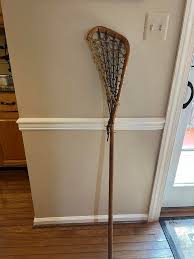 What is the age and value of this traditional wood lacrosse stick?