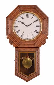 Sold at Auction: Clocks- 2 (Two): (1) New Haven Clock Co., New Haven, Conn., "Bank Regulator", 8 day, time and strike, spring brass movement long drop wall clock, c1911 (2) E. N.
