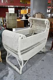 Sold at Auction: Vintage Lloyd Reed Loom style cane bassinet/crib, white painted finish, fitted with steel castors and wire sprung base. 103cm H, 108cm L, 51cm W.
