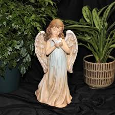 Angel holding dove in Southgate, MI | Riverview Florist