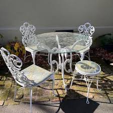 LOT 125P: Aluminum with Stone Inlay High Top Patio Table w/ Built In Ice Bucket and 4 Swivel Stools | EstateSales.org